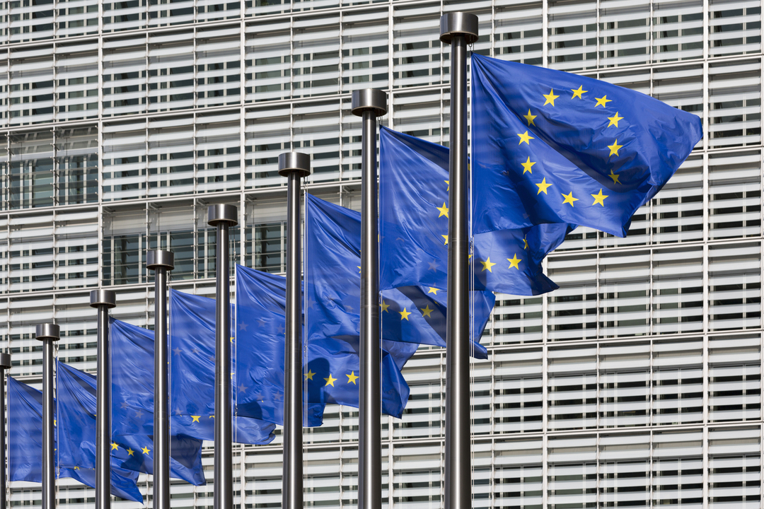 Row of European flags outside Berlaymont building, European Commission headquarters, Brussels, Belgium